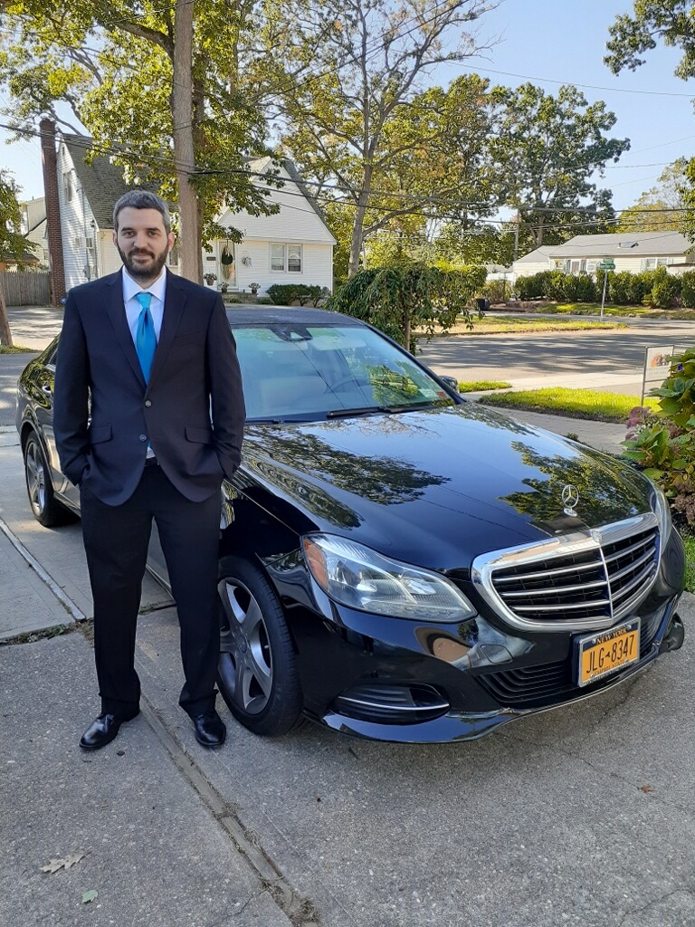Andrew Libert standing beside a Mercedes-Benz